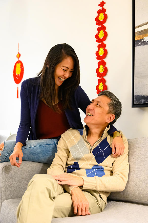 Family celebrating Chinese New Years at home Photograph by stockstudioX