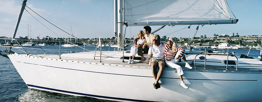 Family Couples Sitting on the Deck of a Sailing Yacht Photograph by Digital Vision.
