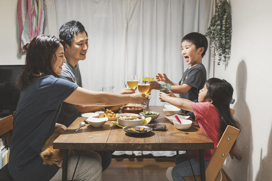 Family having dinner at home Photograph by Kohei_hara