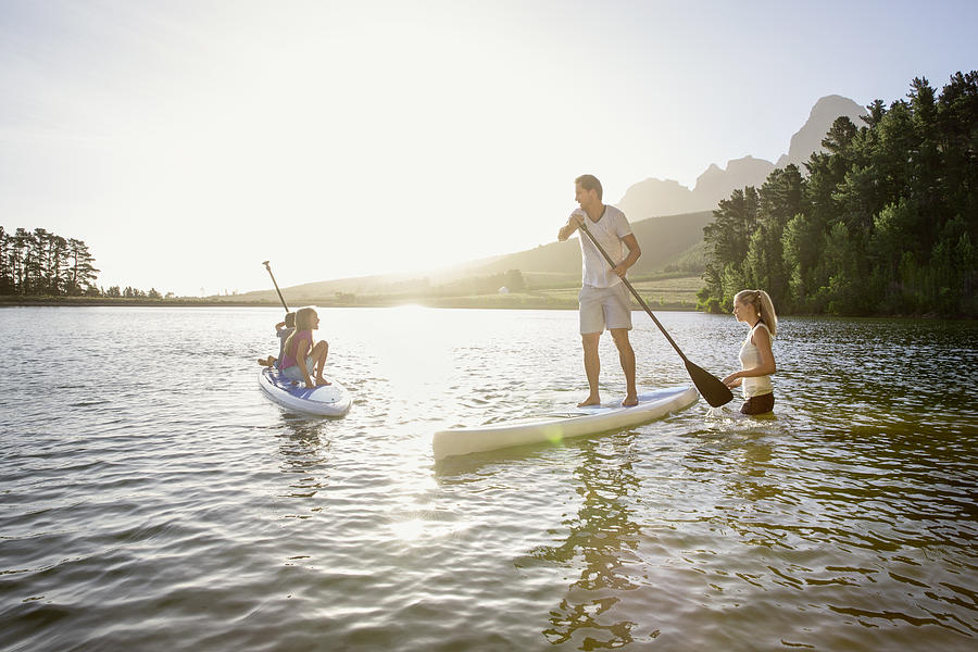 Family learns stand-up paddling Photograph by Markus Bernhard