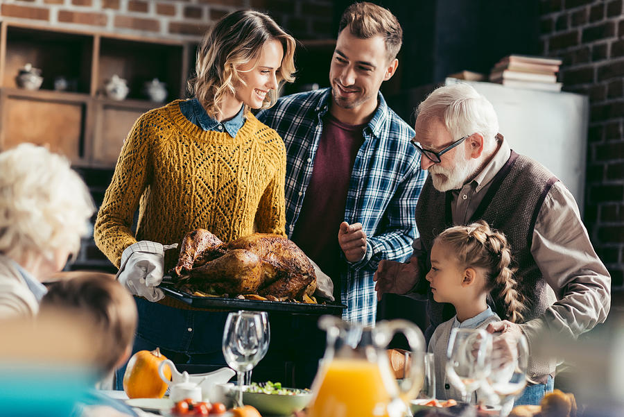 Family Looking At Thanksgiving Turkey Photograph by LightFieldStudios