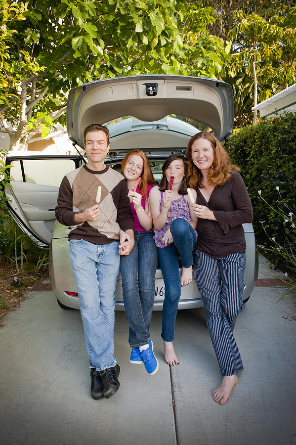 Family Of Four Sharing Popsicles On Car Trunk Photograph by Stephen Simpson