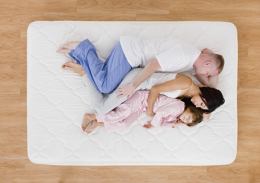 Family on bed Photograph by Vstock LLC