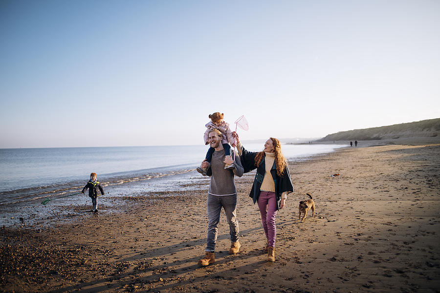 Family on the Beach During Winter Photograph by SolStock