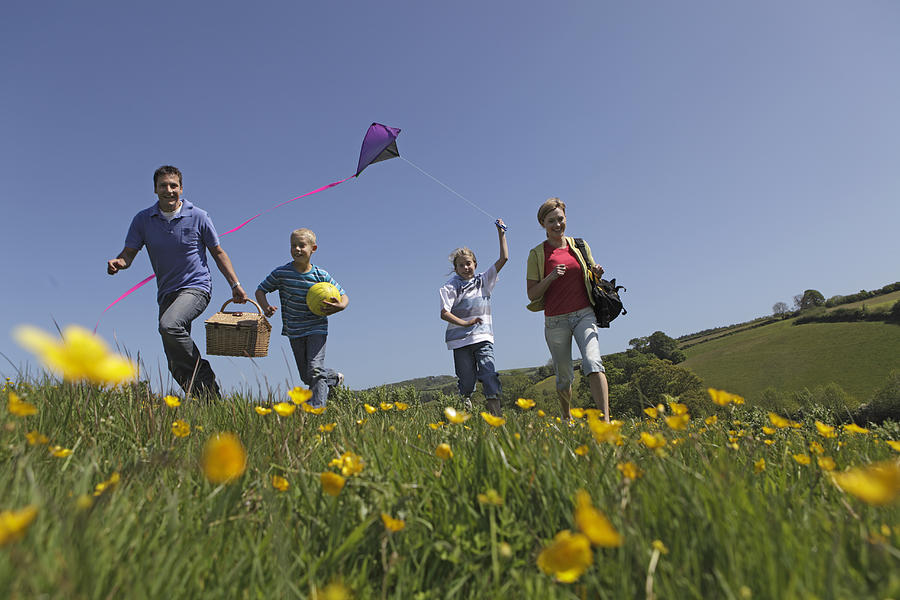 Family Outdoors Together Flying Kite Photograph by Peter Cade