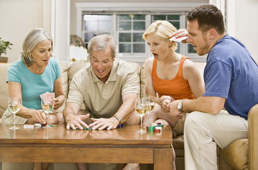 Family playing Poker and drinking wine Photograph by Andersen Ross