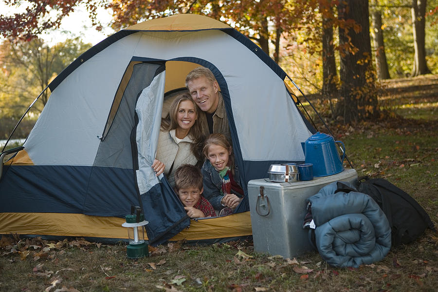 Family sitting in tent Photograph by Comstock Images