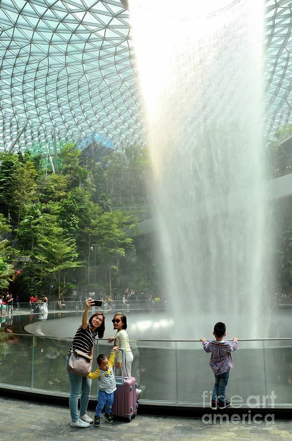 Family takes selfie photograph by waterfall and trees at Jewel Changi airport Singapore Photograph by Imran Ahmed