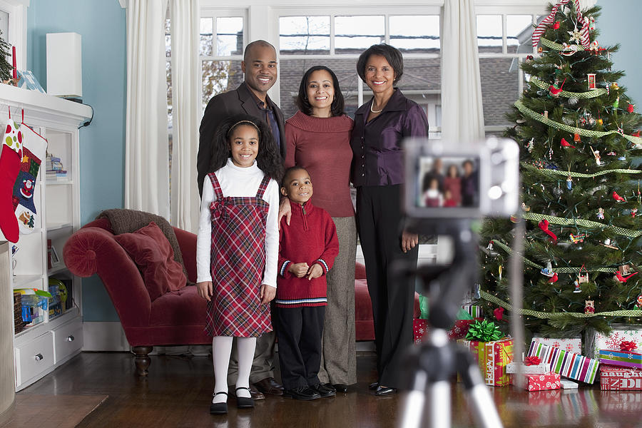 Family taking Holiday portrait with digital camera Photograph by Inti St. Clair