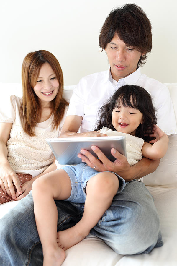 Family using tablet computer Photograph by Kazuhiro Tanda