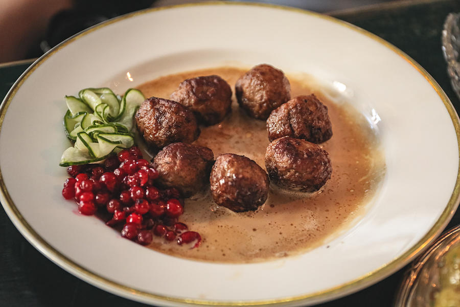 Famous Swedish meatballs with lingonberries and slices of cucumber in gravy sauce, Stockholm, Sweden Photograph by Lingxiao Xie