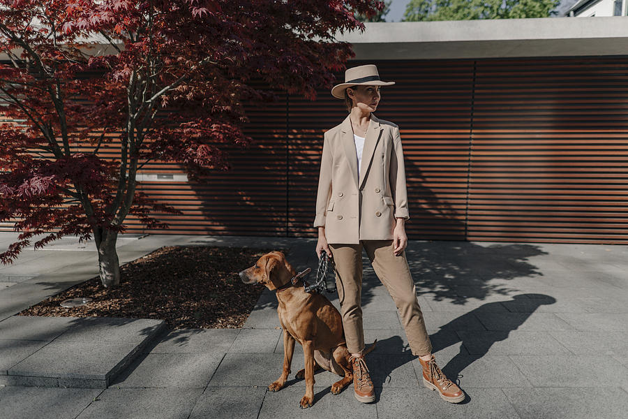 Fashionable woman with her dog in the city Photograph by Westend61