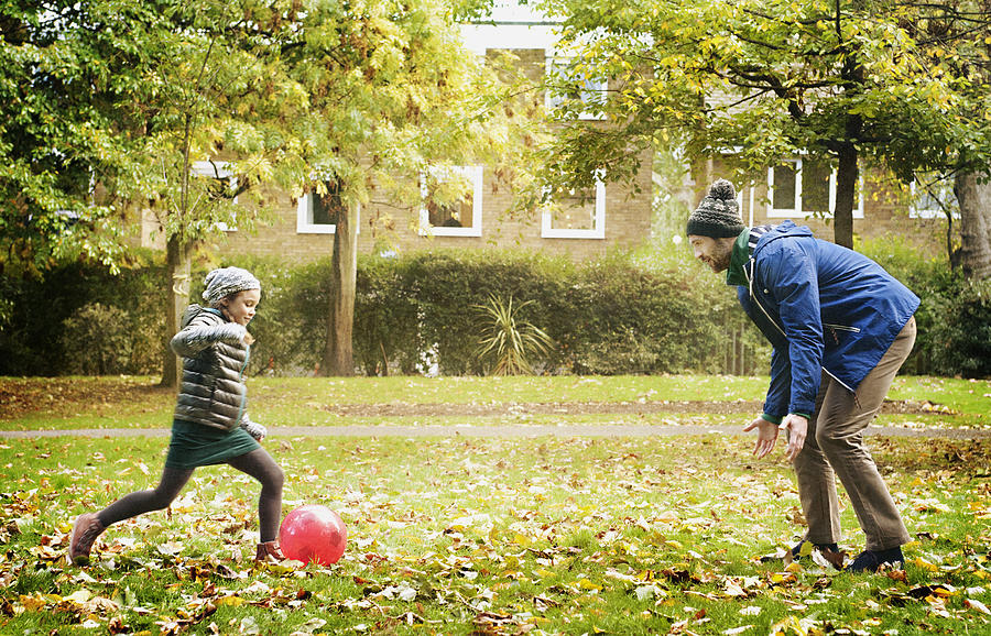 Father & daughter play football in a London park Photograph by Tracy Packer Photography