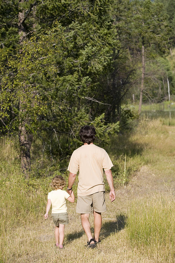 Father and child holding hands while walking Photograph by Comstock Images