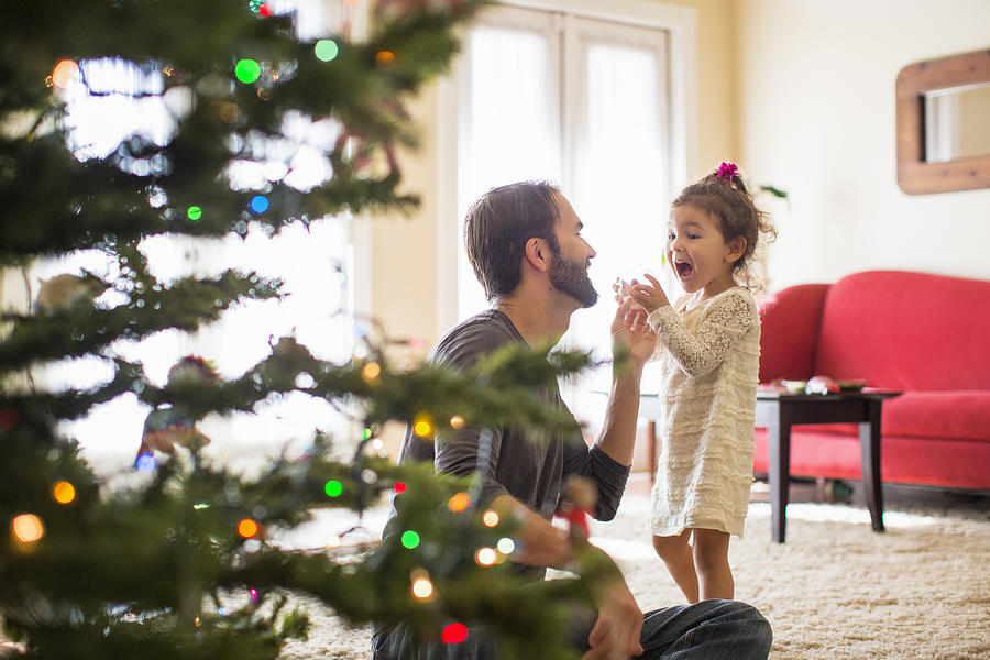 Father and daughter decorating christmas tree Photograph by Romona Robbins Photography