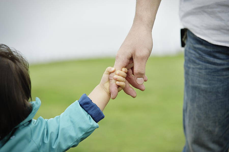 Father and daughter holding hands Photograph by Yagi Studio