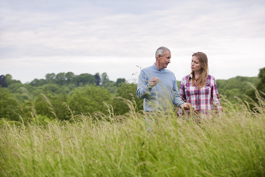 Father and daughter in tall grass Photograph by Colin Hawkins