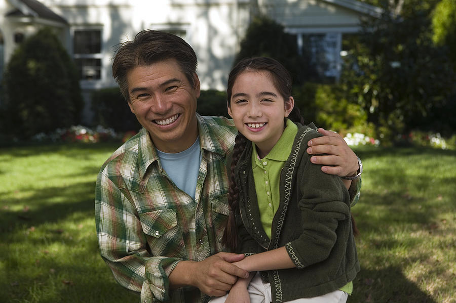 Father and daughter smiling Photograph by Comstock Images