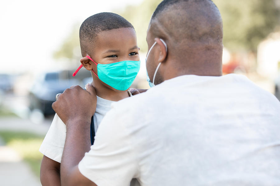 Father and elementary age son wear masks and say goodbye as father drops son off for first day back to school during time of coronavirus Photograph by Courtney Hale