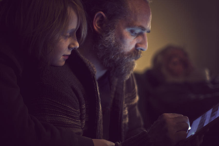 Father and Son bonding over tablet computer Photograph by Catherine MacBride