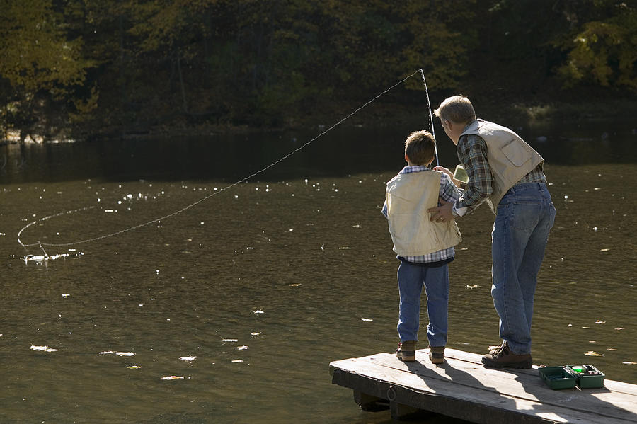Father and son fishing Photograph by Comstock Images