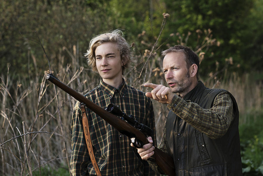 Father and son in nature with rifle Photograph by Robin Skjoldborg