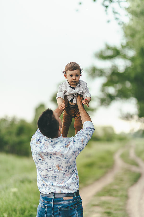 Father and son outdoors having fun Photograph by PhotoAttractive