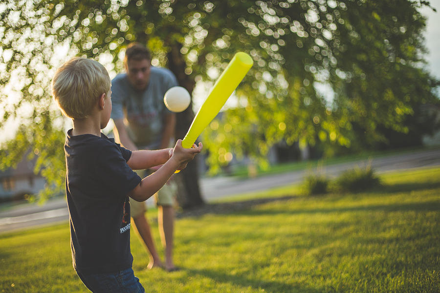 Father and son playing baseball Photograph by Annie Otzen