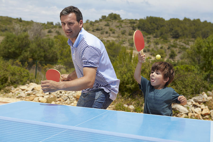 Father and son playing table tennis Photograph by Frank and Helena