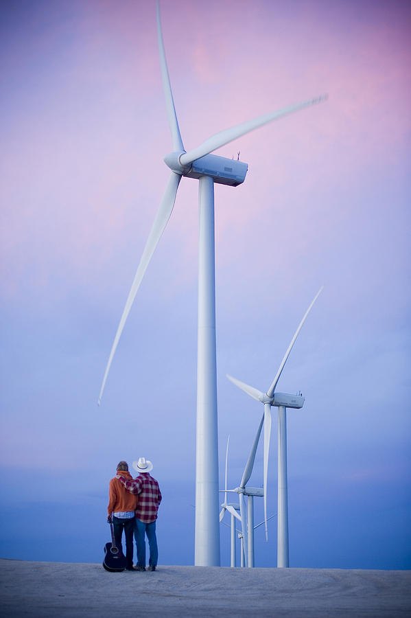 Father and son with guitar at wind farm Photograph by Stephen Simpson