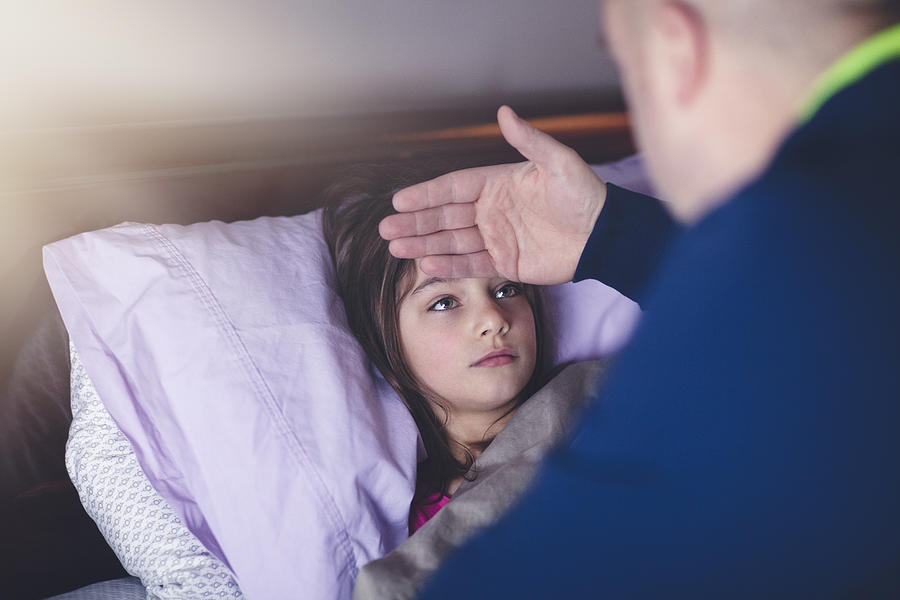 Father Checking Daughters Forehead For Fever Photograph by Rebecca Nelson