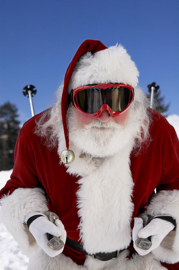 Father Christmas Skiing on a Ski Slope Photograph by Digital Vision.