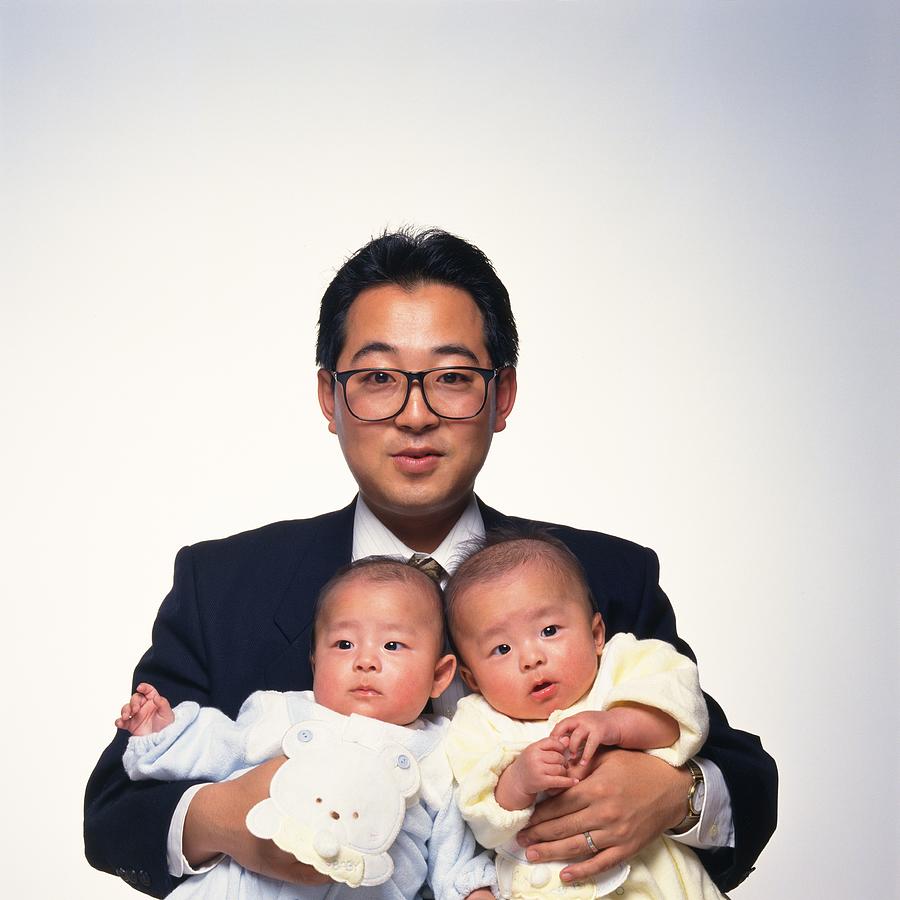 Father holding twins baby boys Photograph by Daj