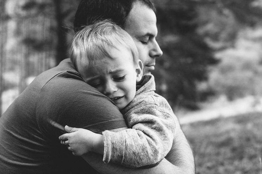 Father hugging his crying son Photograph by Martin-dm