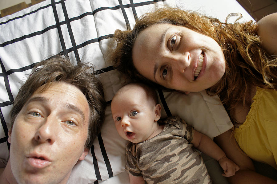 Father, Mother and newborn daughter in a selfie. Photograph by Graiki