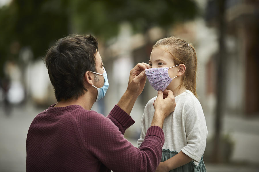 Father Putting Home Made Face Mask on Little Daughter Photograph by Morsa Images