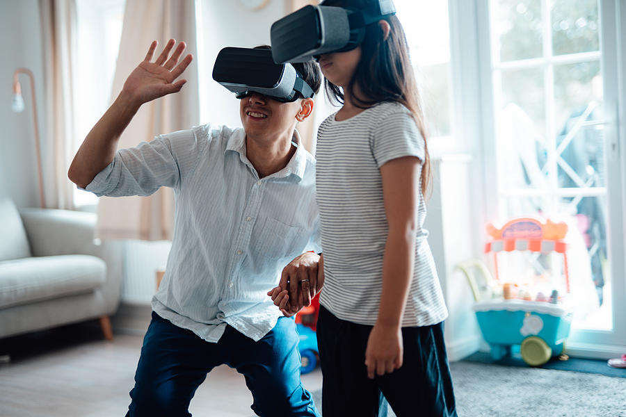 Father Using Virtual Reality Headset With His Daughter Photograph by Oscar Wong