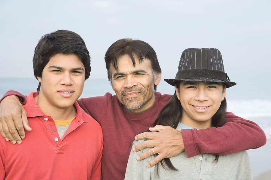 Father with sons at beach, portrait, smiling Photograph by Ronnie Kaufman
