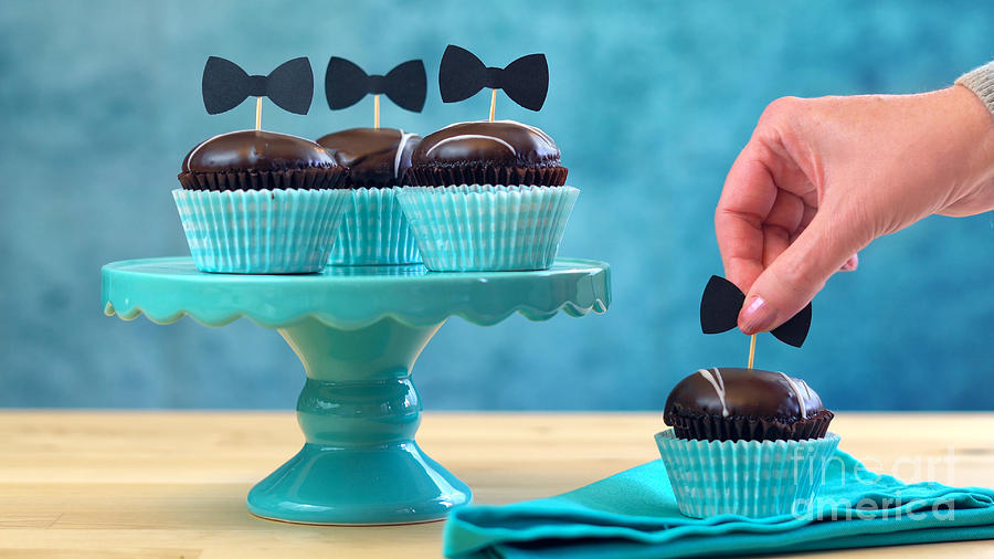 Fathers Day close up of chocolate cupcakes on cake stand on table. Photograph by Milleflore Images