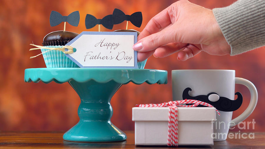 Fathers Day close up of gift, cupcakes and coffee. Photograph by Milleflore Images