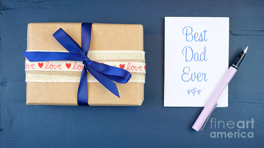 Fathers Day overhead with gift and Best Dad Ever card. Photograph by Milleflore Images
