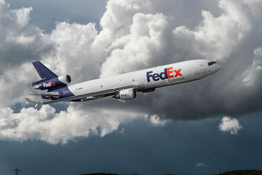 FedEx MD-11F in the Clouds Mixed Media by Erik Simonsen