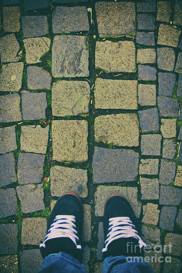 Feet in urban sneakers on cobblestones Photograph by Mendelex Photography