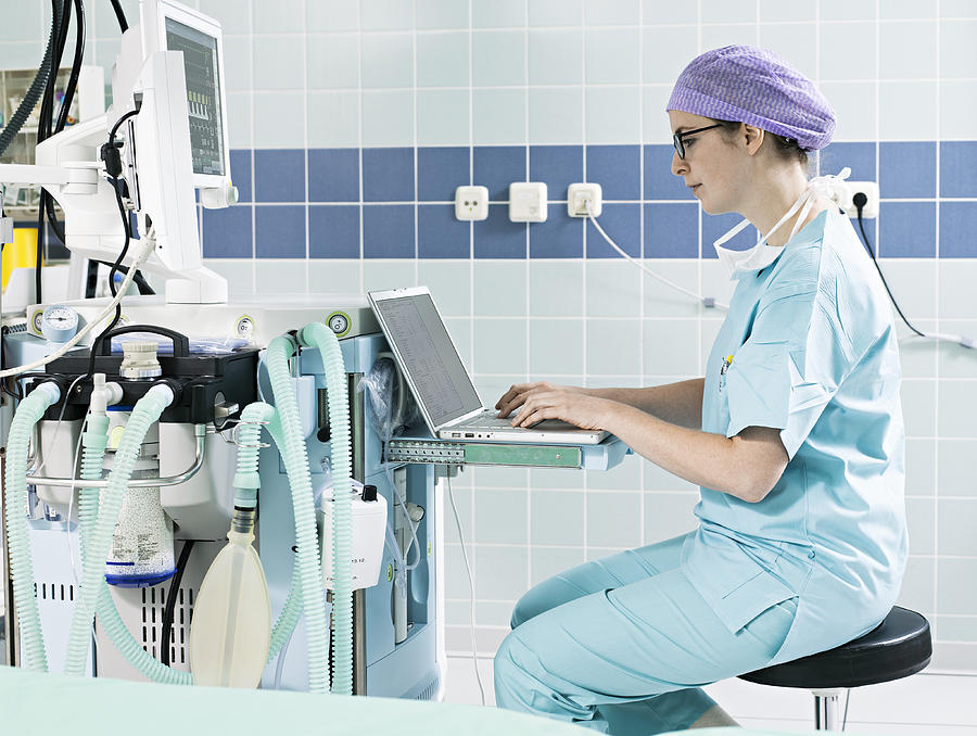 Femal Surgeon Using Laptop Photograph by Joos Mind