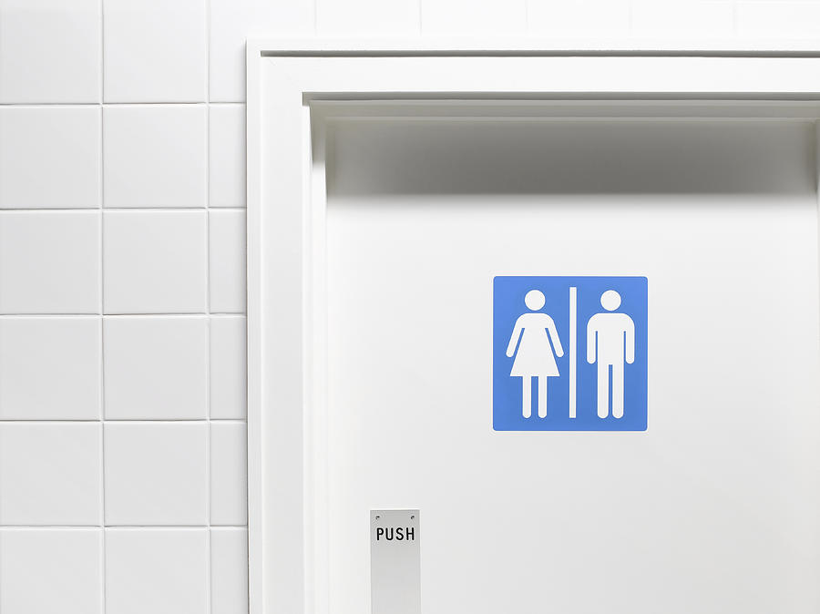 Female and male sign on toilet door, close-up Photograph by Peter Dazeley