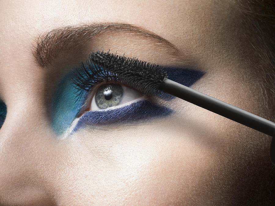 Female applying mascara, close up Photograph by Jonathan Knowles
