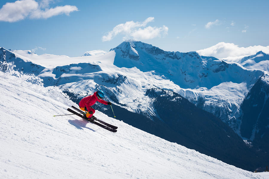 Female athlete skiing in the mountains Photograph by stockstudioX