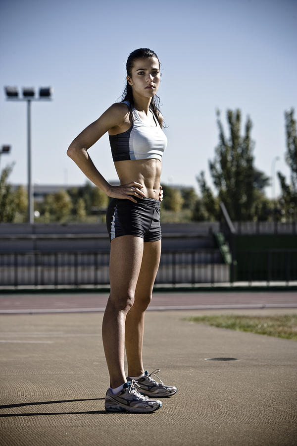 Female athlete standing with hand on hip Photograph by Ssc