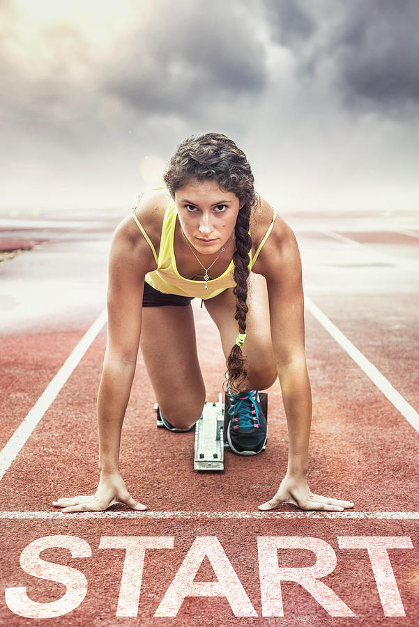 Female athlete with yellow too in the starting blocks Photograph by SeanShot