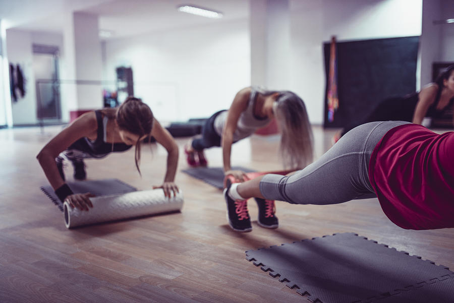 Female Athletes Working Out Together During Fitness Class In Gym Photograph by AleksandarGeorgiev